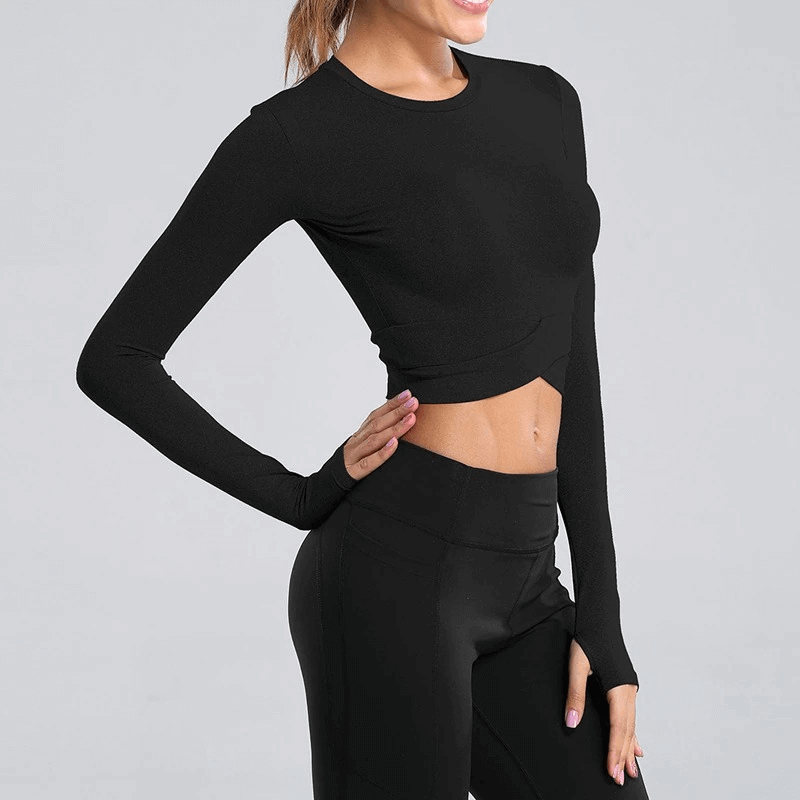 Women's slim-fit long sleeve black crop top for yoga, featuring a crew neck and cross waist design, shown on a model.